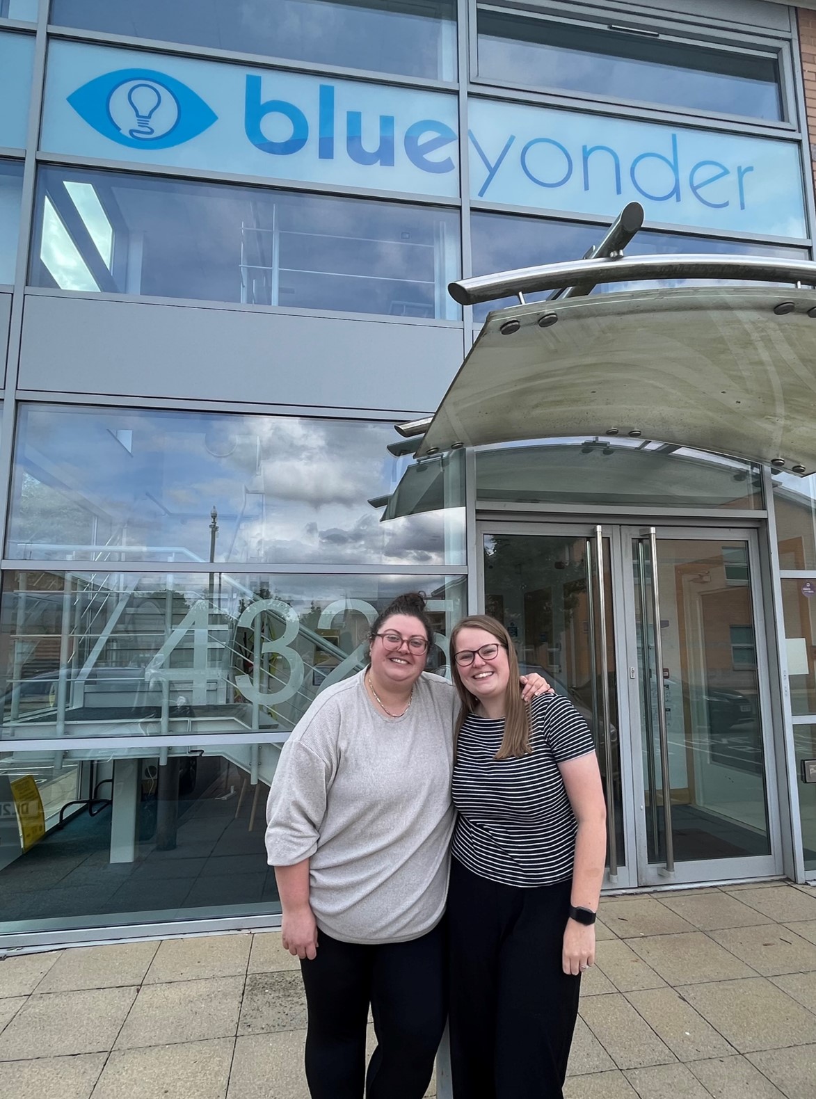 Abbie and Hannah pose in front of the Blue Yonder office for the Innovation Awards